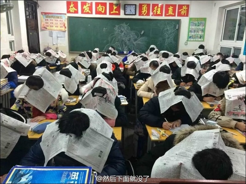 Pic Shows: The teacher ordered kids to a wear cardboard box on heads to avoid cheating in the exam;A school teacher is in hot water after making students take part in an exam with a cardboard box on their head.